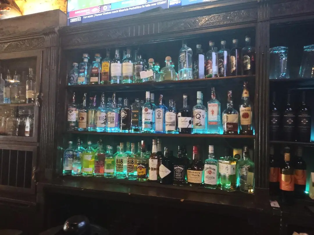 Bottles lit along the back bar shelves at Old Towne Pub